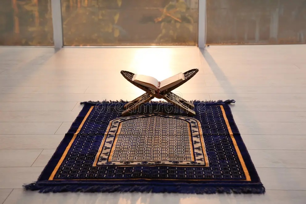 Prayer mat and Quran neatly placed in a tent